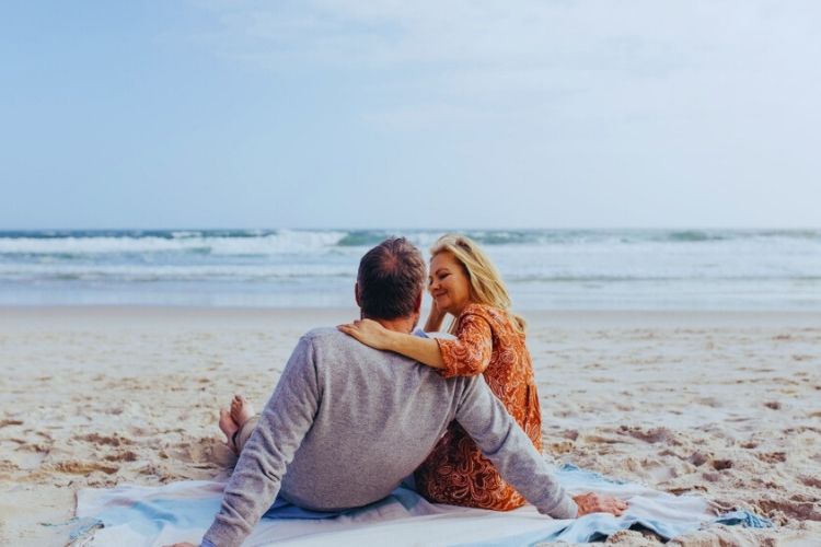 Financial Adviser Gold Coast - Couple seated on the beach sand